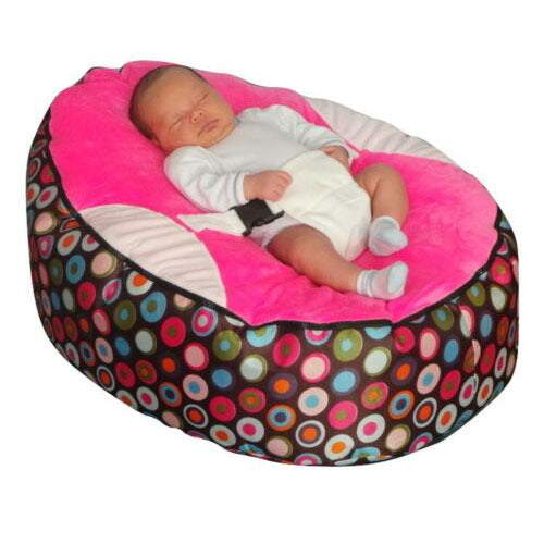 Baby sleeping in colorful Babybed Luie cushioned baby chair with polka dot pattern