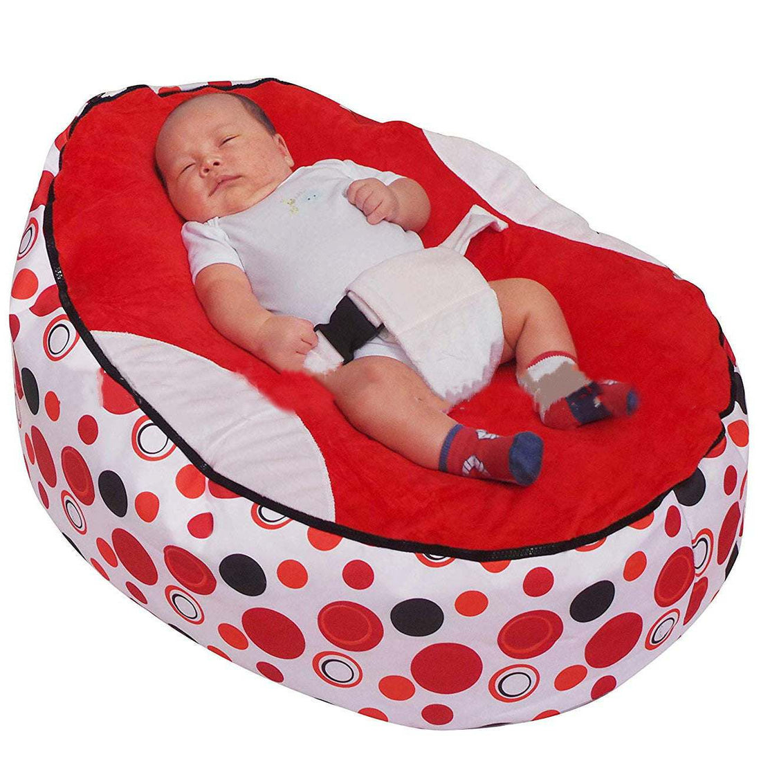 Baby sleeping in colorful Babybed Luie cushioned baby chair with polka dot pattern