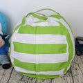 green and white striped canvas plush toy storage bag on wooden floor next to stuffed animal and toy car
