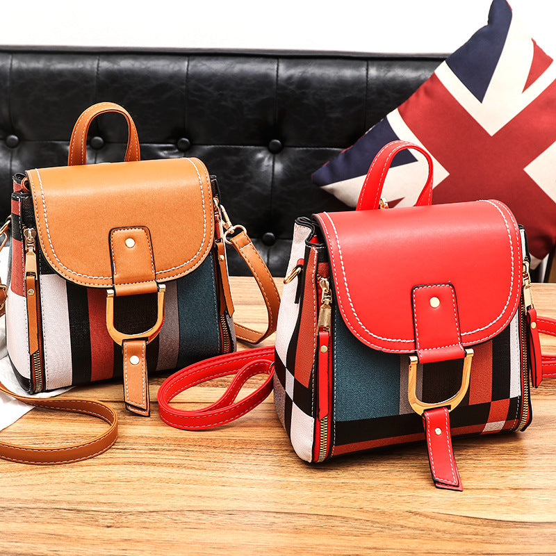 Female PU crossbody handbag with gold hardware, multicolor stripes, and black top flap, compact and stylish shoulder bag