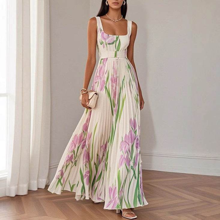 Mouwloze formele geplooide jurk met bloemenprint in lichte pasteltinten, hoge taille en schouderbanden.