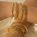 Gold-plated stainless steel ornament bracelets in various chain styles on wrists