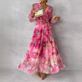 dames lange mouwen bloemenprint jurk met V-hals en geplooide hoge taille in roze chiffon maxistijl