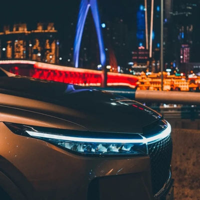car front hood with sleek LED Daytime Running Light strip illuminated in blue at night