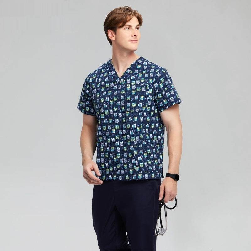 man wearing blue patterned chirurgische jas medical scrub top and navy pants with stethoscope on gray background