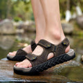 Breathable men's outdoor beach sandals in dark brown leather with adjustable Velcro straps and rubber sole