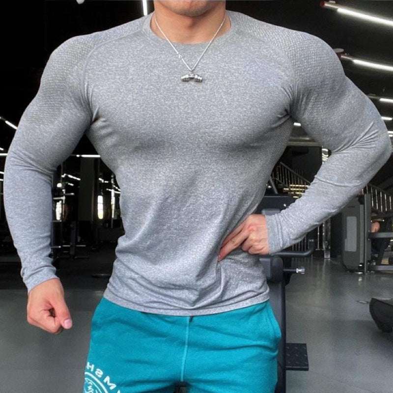 Man in sports gymwear wearing a slim fit grey seamless long sleeve training top with raglan sleeves