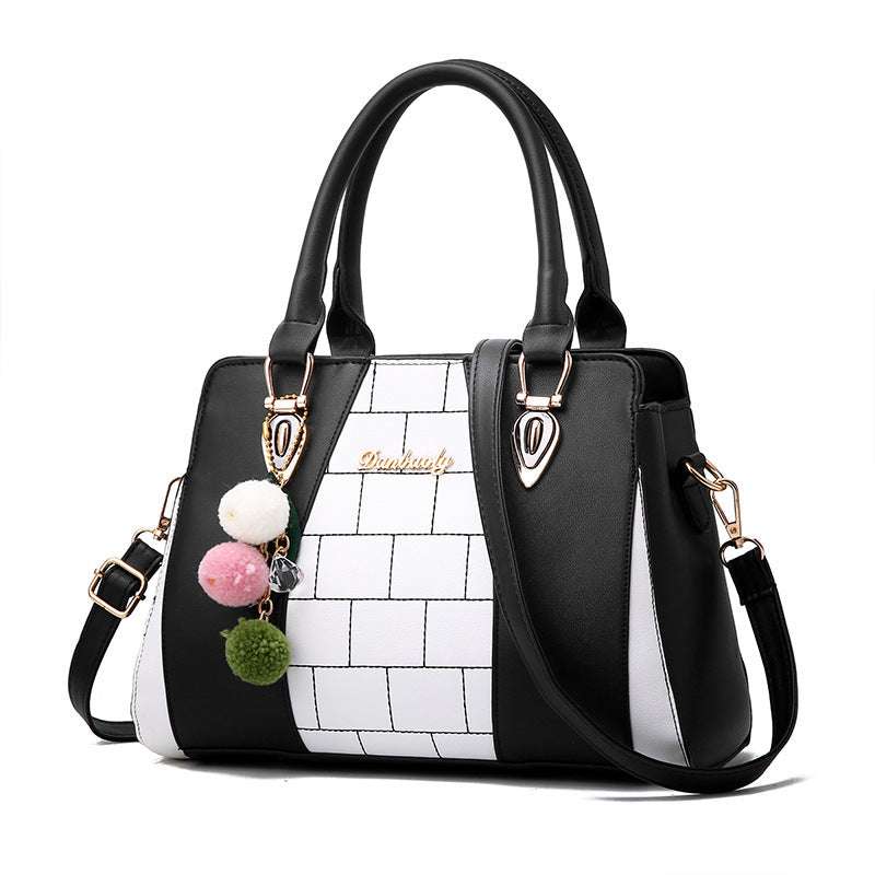 Black and white PU leather shoulder bag for women with pompom decoration and zipper closure